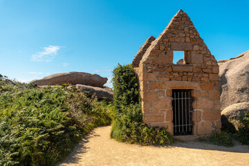 Stone dwelling along Lighthouse Mean Ruz, port of Ploumanach, in the town of Perros-Guirec in the Cotes-d'Armor department, in French Brittany, France.