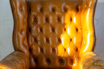 Brown leather armchair in loft design apartment.