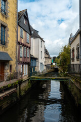 Fototapeta na wymiar Traditional wooden houses by the river in the medieval town of Quimper in the department of Finisterre. French Brittany, France