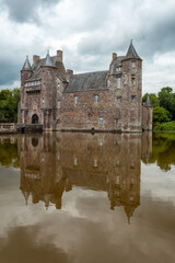 Obraz premium The beautiful lake of the Chateau Trecesson, medieval castle, Campénéac commune in the Morbihan department, near the Broceliande forest.