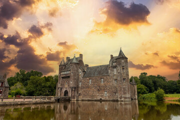 Sunset on the beautiful lake of Chateau Trecesson, medieval castle, Campénéac commune in the...
