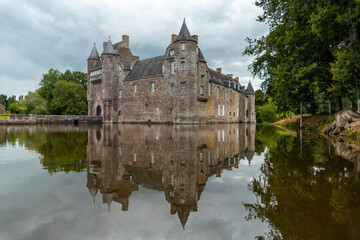 Reflections of the medieval Chateau Trecesson in the lake, Campénéac commune in the Morbihan...