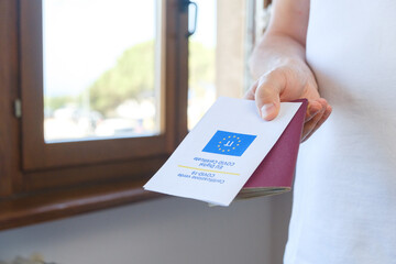 Unrecognised Vaccinated Male Showing Paper EU Digital COVID Certificate and Italian Passport. Coronavirus Vaccination Advertisement Campaign. Vaccine Done