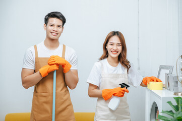 Smiley Young couple happy with cleaning home together