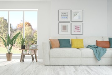 Stylish room in white color with sofa and autumn landscape in window. Scandinavian interior design. 3D illustration