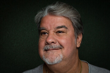 Man headshot closeup while he is with a little smile looking away