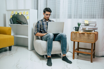 Young man working from home with laptop computer