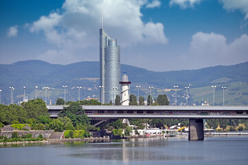 Fototapeta premium Lighthouse and skyscraper on Danube river in Vienna