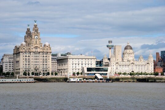 The Pier Head (or George's Pier Head) riverside location in the city center of Liverpool, England with "The Three Graces" seen from the River Mersey, UK