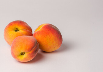 Three juicy, ripe large peaches lie on a white background, shot close-up, macro,  Flat Lay