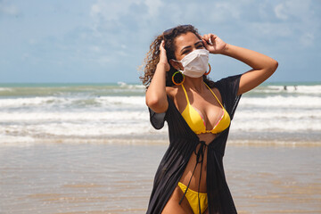 Woman wearing medical mask at beach, new normal rules, web banner. Life after pandemic, obligatory...