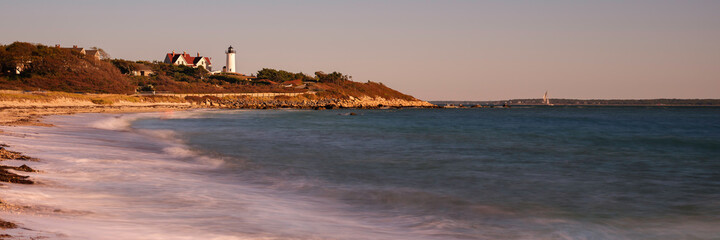 Panoramic seascape with a view of Knobska Light over the green hill in Woods Hole, Massachusetts