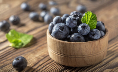 healthy blueberries on the table in a wooden bowl