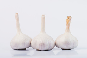 Garlic on a white isolated background. Head of young garlic. 