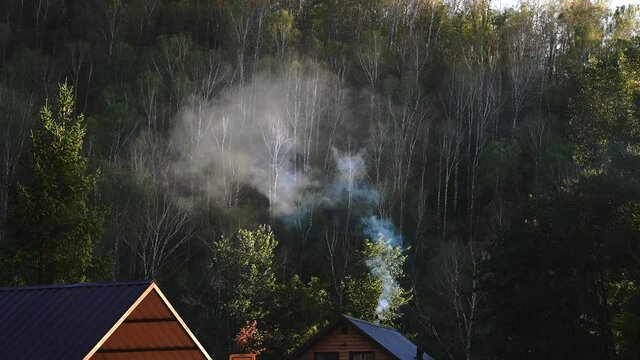 Smoke coming out of the chimney. Relax in the mountains, tourism