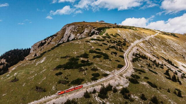 Schafbergbahn Cog Railway running from St. Wolfgang up the Schafberg, Austria.Journey to the top of Alps through lush fields and green forests.Beautiful mountain panorama.View of lake Wolfgangsee.