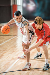 Fototapeta premium Two young men playing basketball and feeling excited