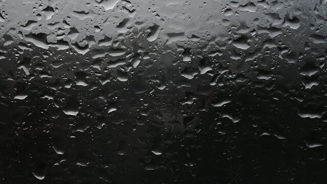 Closeup of rain drops on teh window. Rainy weather concept.