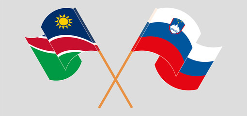 Crossed and waving flags of Namibia and Slovenia