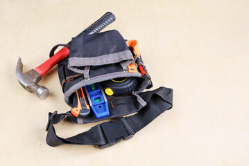 Construction bag on belt for working tools on plywood of surface with copy space