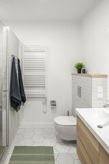 Modern minimalist bathroom interior design with white tiles, two white sinks and natural wood furniture