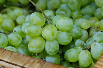 bunches of green grapes on the store counter close up