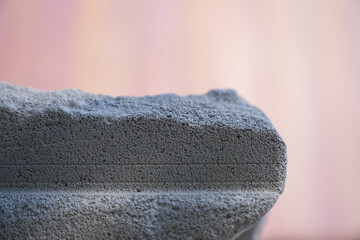 The podium is made of gray stone on a pink background. A pedestal for your product. Horizontal...