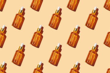 Seamless pattern of anti aging serum in glass bottle with dropper on pastel orange background....