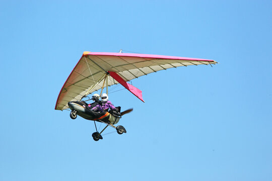 Ultralight airplane flying in a blue sky