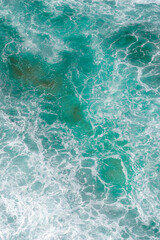 Aerial view of the ocean waves and beach. Blue water background. Sea top view. Atlantic Ocean beach with sand texture	