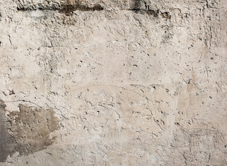 Concrete plaster sunny wall with scratches