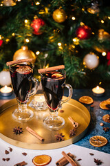 Mulled wine with cinnamon and orange served in festive Christmas decoration