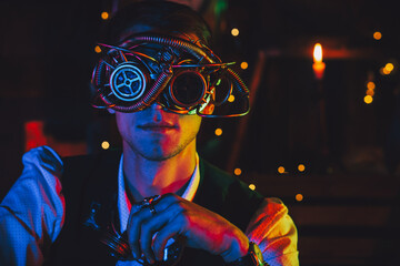 portrait of a male engineer in cyberpunk glasses and a steampunk suit in a workshop © alexkoral