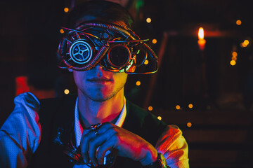 portrait of a male engineer in cyberpunk glasses and a steampunk suit in a workshop