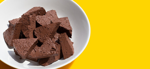 Chicken blood tofu in white bowl on yellow background