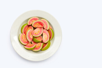 Fresh pink guava in white plate on white background.