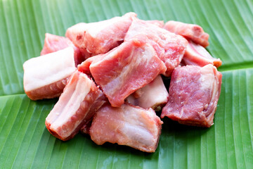 Raw pork ribs on banana leaf