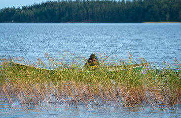 Fisherman on boat at lake