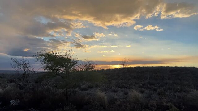 Driving Past Beautiful Orange Sunset Countryside Trees Clouds In Sky