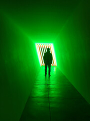 Person Standing in A Fluorescent Tunnel
