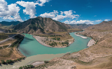 Fototapeta na wymiar The confluence of two rivers, Katun and Chuya, the famous tourist spot in the Altai mountains, Siberia, Russia, aerial drone shot.
