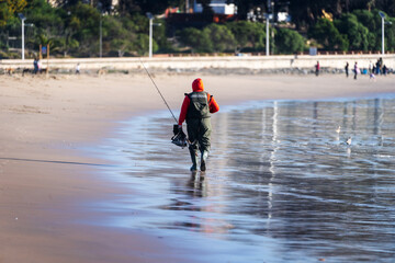 fisherman on the beach walking home