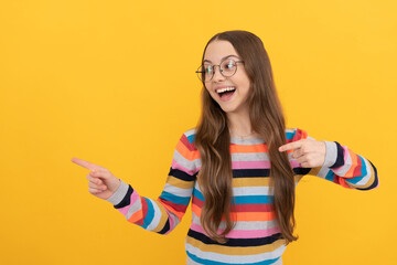 happy smart kid. teen girl in eyeglasses pointing fingers. vision acuity. eyesight.