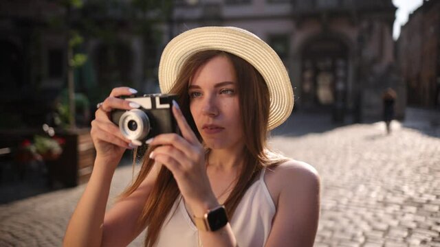 Travel photographer making pictures in hipster style hat. Travel tourist woman