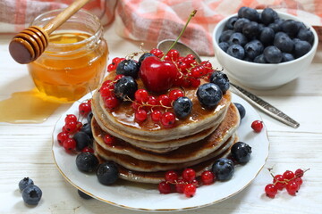 pancakes with berries and honey