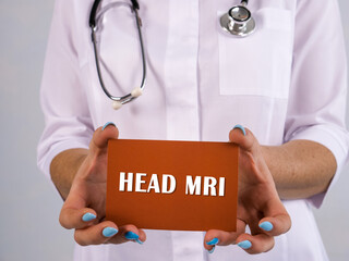 Medical concept about HEAD MRI Magnetic Resonance Imaging with phrase on the sheet.