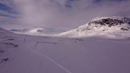 A tiny lonely skier in Lapland near Alesjaure, Sweden, early April