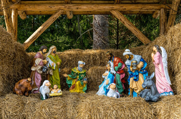 Rustic nativity scene. The hayloft and statues with Christmas characters