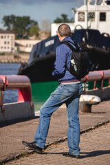 man with a backpack standing in port