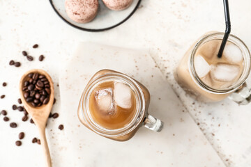 Composition with mason jar of tasty iced coffee on light background